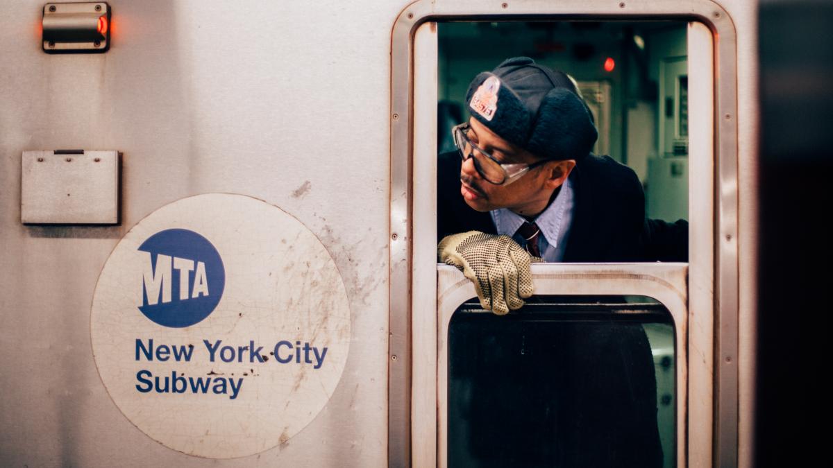NYC Subway conductor checking passenger boarding and exiting the train