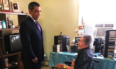 Congressman Espaillat speaking with a woman in a wheelchair about Healthcare