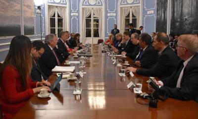 Gathering of people at a long table discussing Foreign Affairs