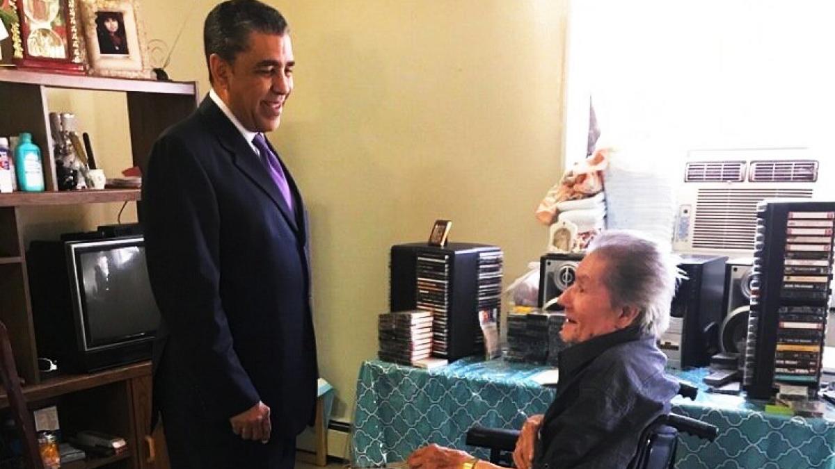 Congressman Espaillat speaking with a woman in a wheelchair about Healthcare